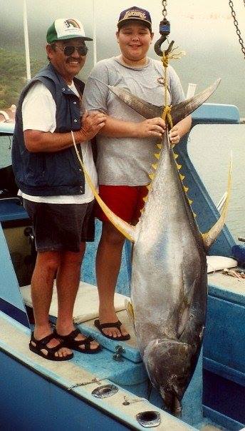 Anthony fishing with his dad at Sand Island as a boy